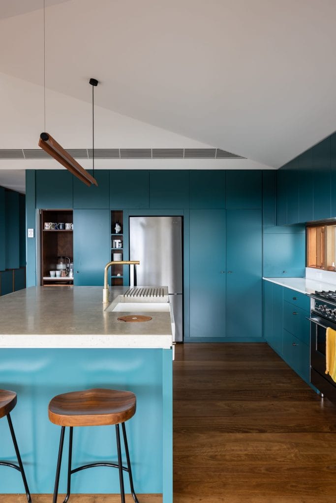 Kitchen with blue cabinetry and timber accents in a Thirroul project by YourBuild Construct
