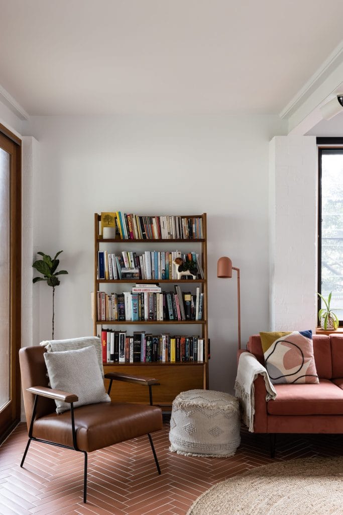 Renovated living room with mid century modern furniture and chevron tiled flooring