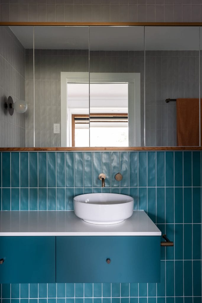 Detail of modern retro ensuite teal vanity and mirrored cabinet by YourBuild Construct