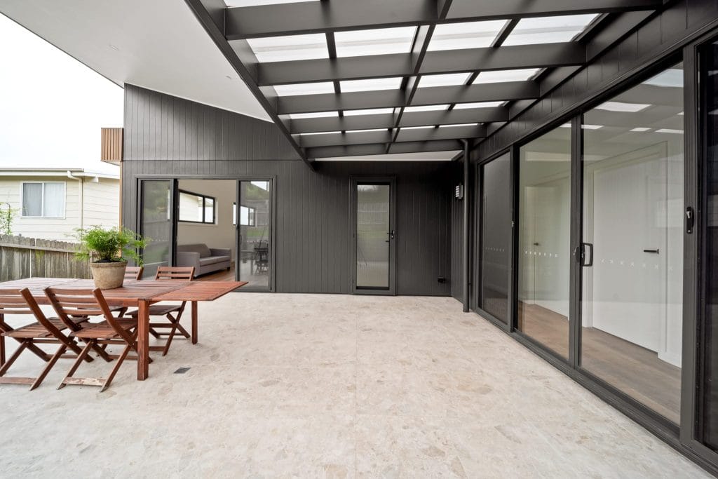 A modern black and grey residential terrace in Werri Beach NSW by YourBuild Construct