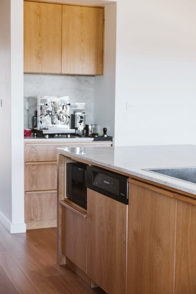 Detail of kitchen island with in built dishwasher and coffee station