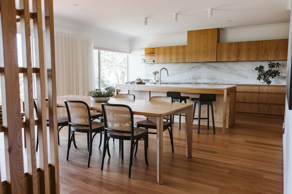 Wide view of the timber kitchen and dining room in Minnamurra NSW by Your Build Construct