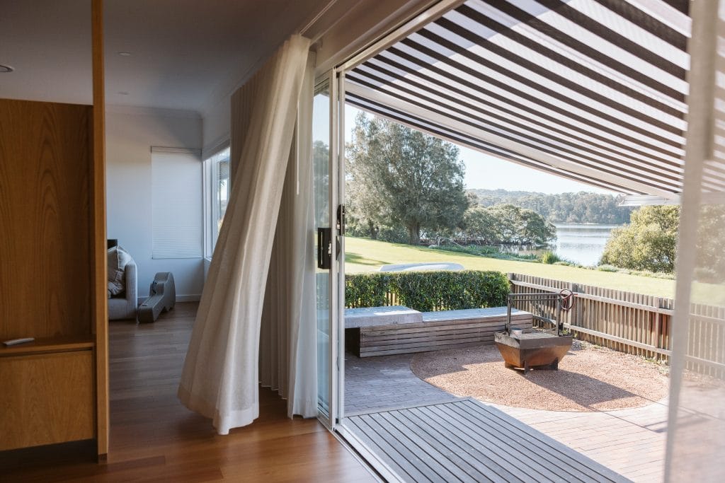 View from a dining room across the backyard to Minnamurra River