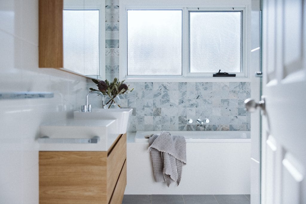 A renovated contemporary bathroom in Minnamurra by YourBuild Construct