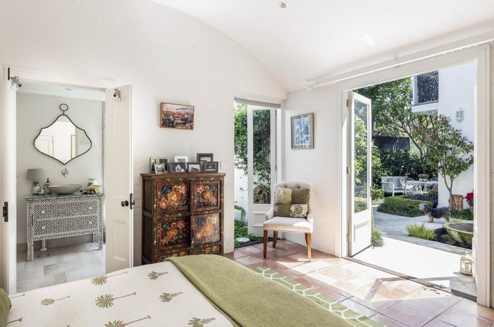 Wide view of a renovated tiled bedroom with French doors opening onto a courtyard garden in Paddington NSW