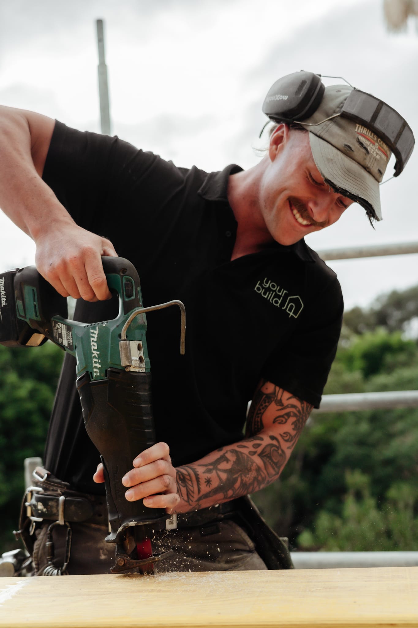 A team member from YourBuild Construct using power tools while on a construction site