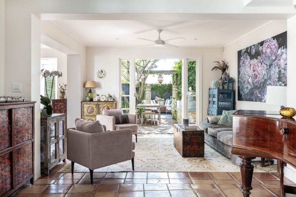 Wide view of an eclectic sitting room in Paddington NSW with view out to courtyard garden