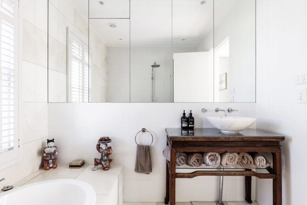 Bathroom renovation by YourBuild Construct with vintage table vanity