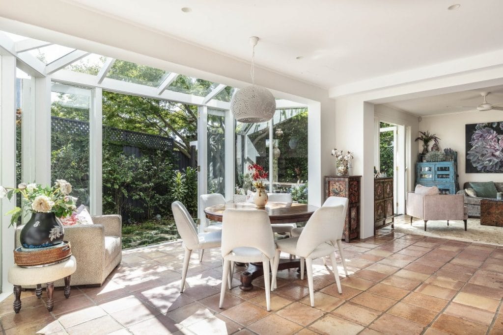 A renovated dining room, living room with glass conservatory in Paddington NSW by YourBuild Construct